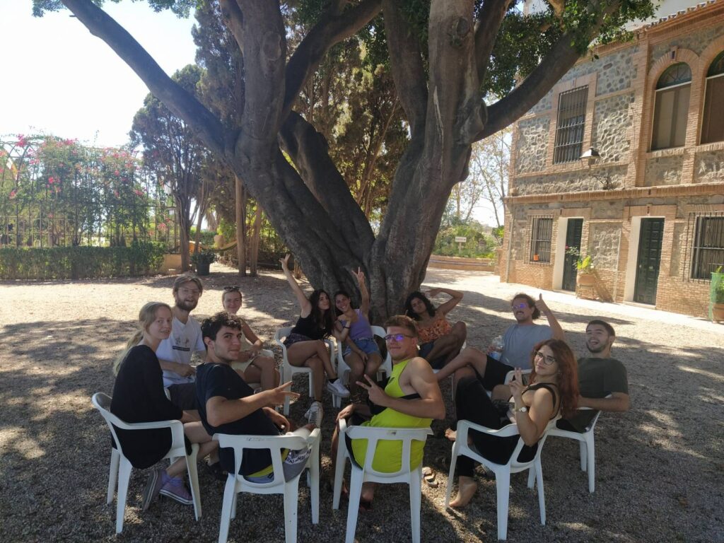 Erasmus+ Youth Exchange See U Potential. The group having activities in the garden, under a tree.